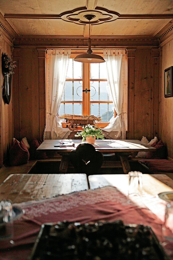 View of dining area in living room of Oberhaslerhof, Italy