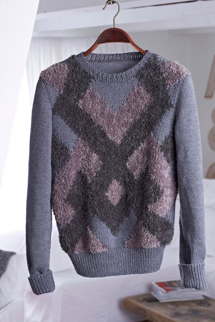 Grey sweater with zig zag pattern on hanger