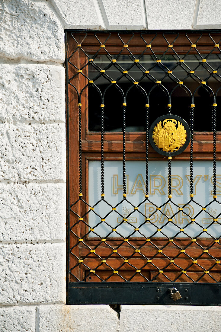 Close-up of lattice window of Harry's bar, Venice, Italy