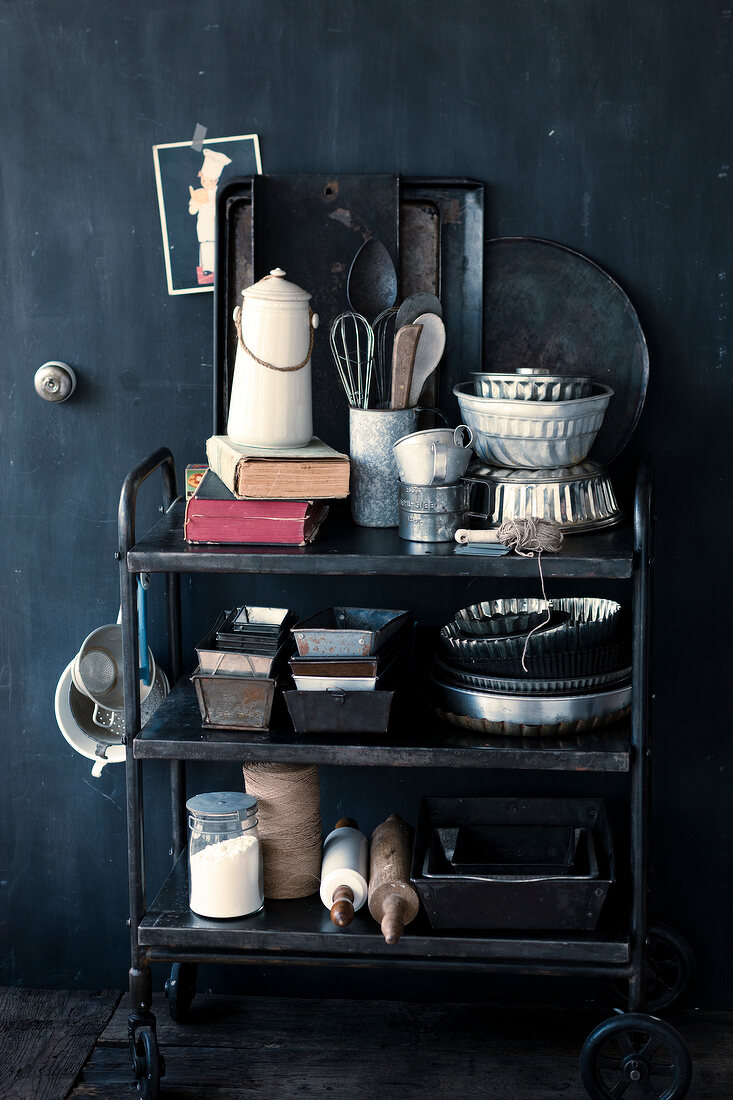 Various antique baking utensils in metal shelf