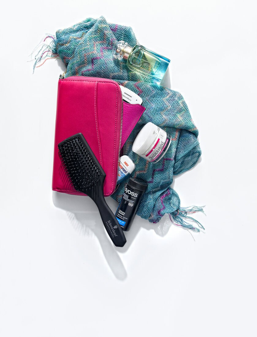 Handbag, brush, scarf, cosmetics and pouch on white background, overhead view