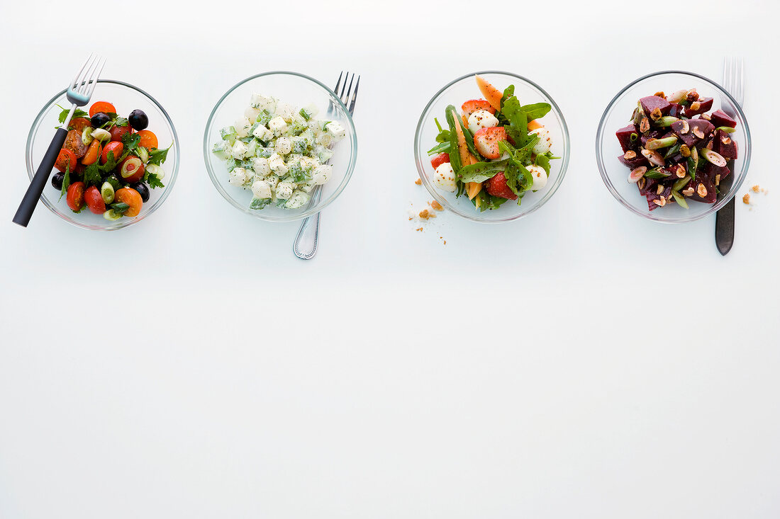 Four different vegetable salads in bowls