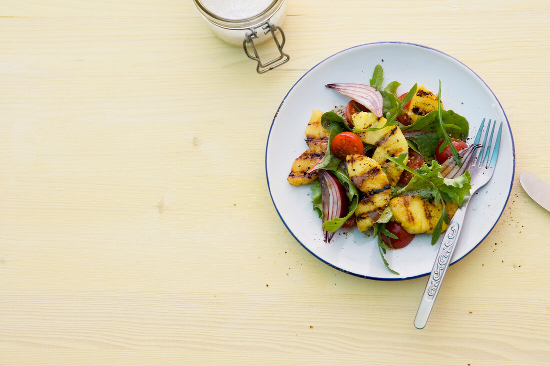 Salad with grilled pineapple on plate