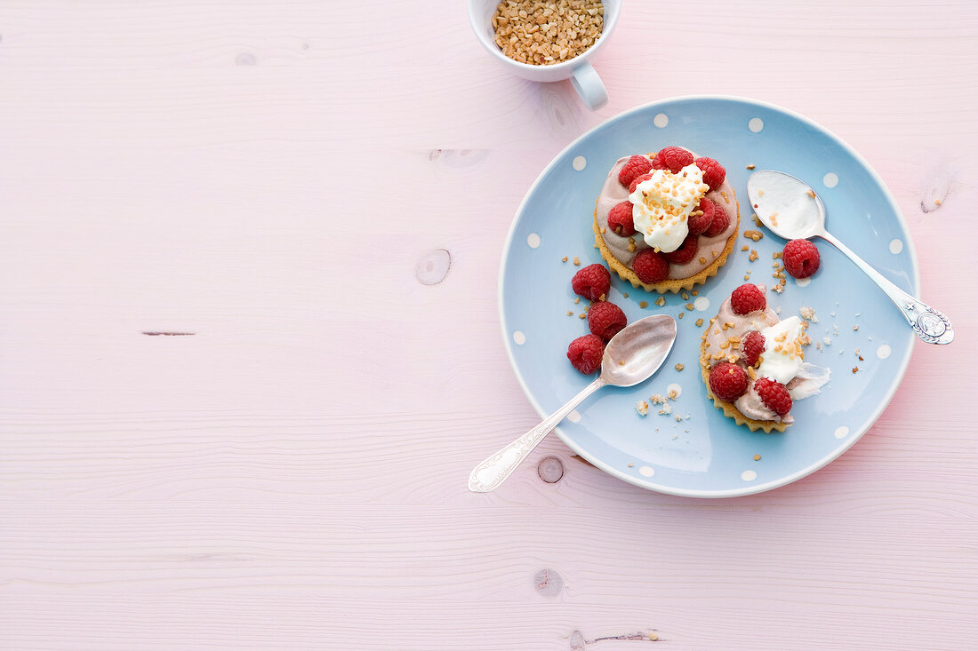 Raspberry chocolate tarts on plate