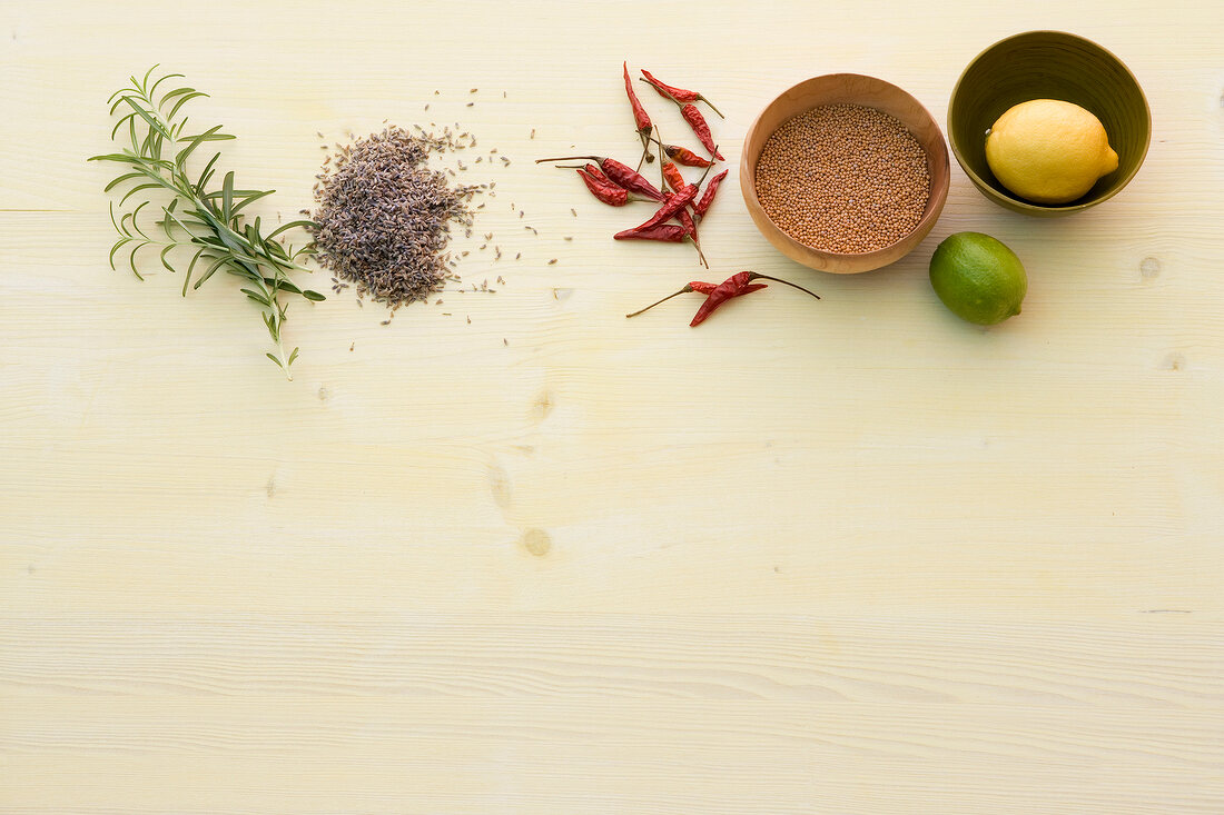 Different ingredients and spices in bowl and wooden background