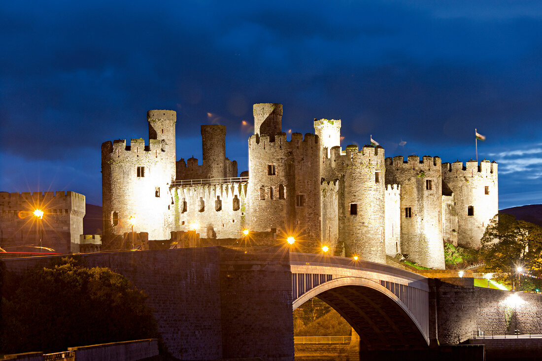 View of illuminated Conwy castle and river Conwy at Wales, UK