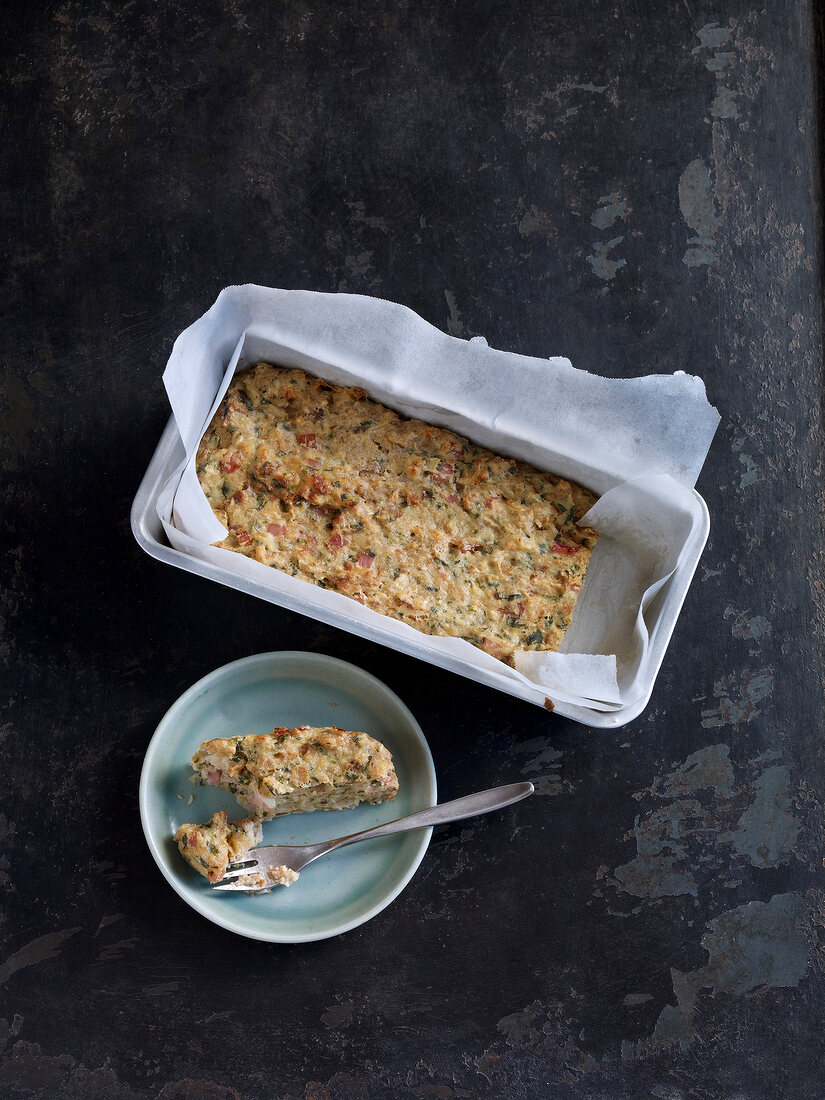 Gratin bread in baking pan and on plate with fork