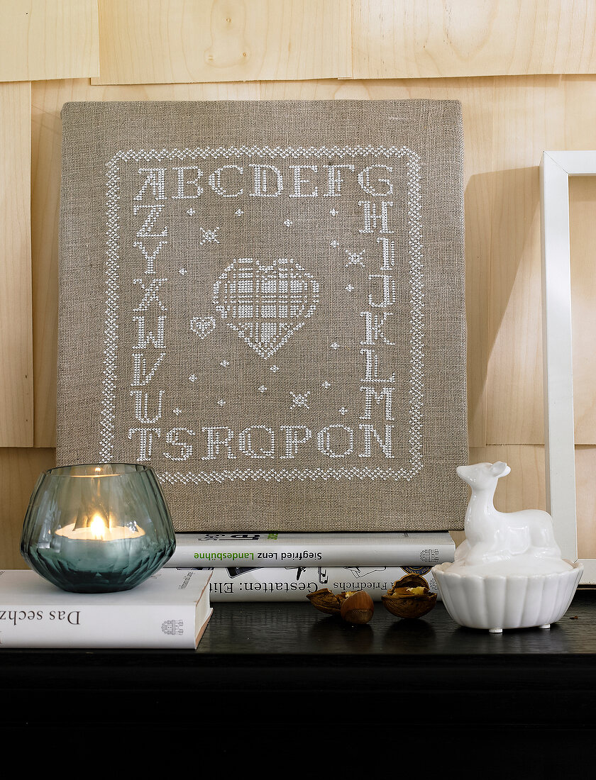 Linen image with embroidered alphabets on shelf