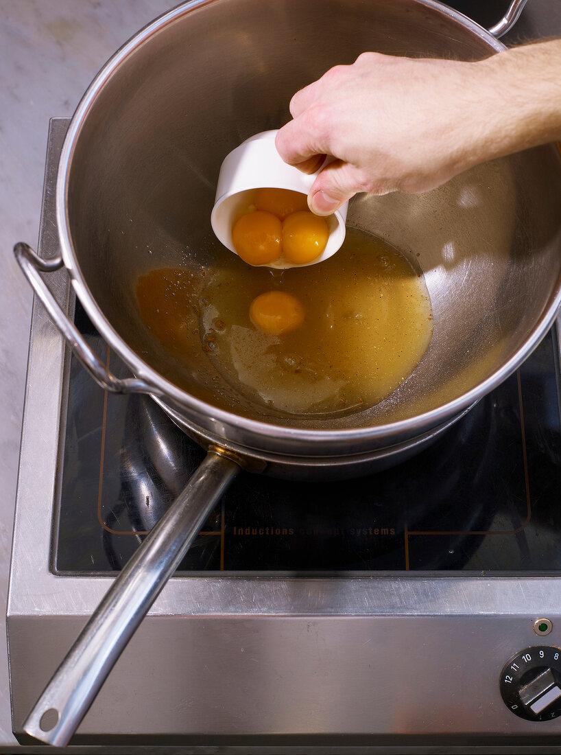 Eggs pour in stainless steel bowl