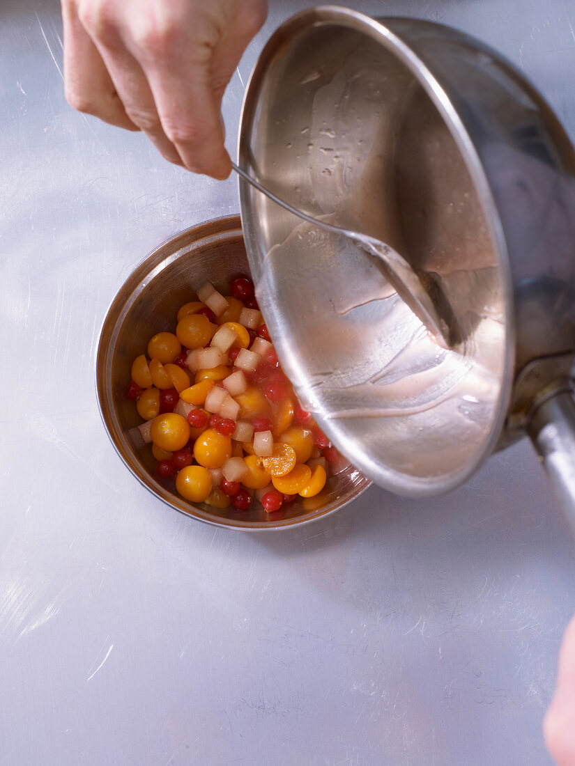Sugar syrup being poured in rum pot vegetables