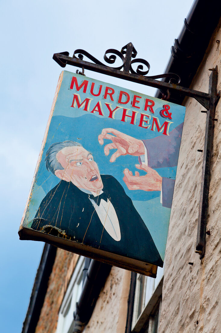 Low angle view of signboard on exterior wall of bookstore in Hay-on-Wye village, Wales, UK