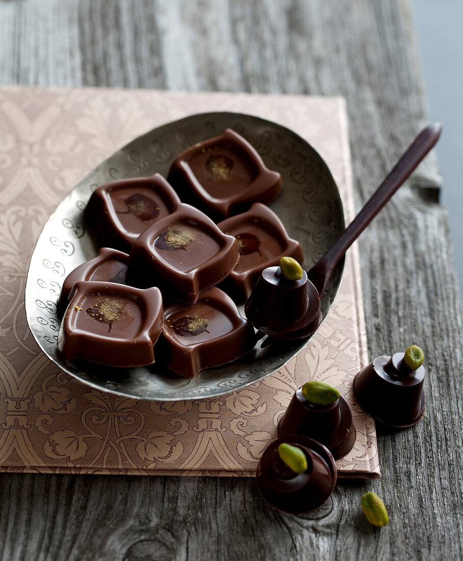 Pistachio chocolates with pistachio toping in bowl
