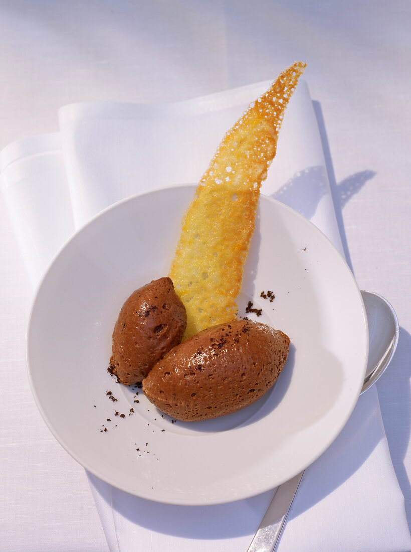 Chocolate mousse with orange hippe on plate
