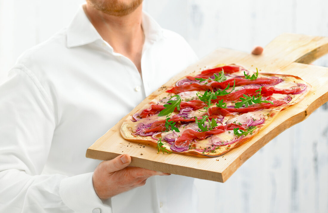 Tarte with taleggio and parma ham on wooden platter