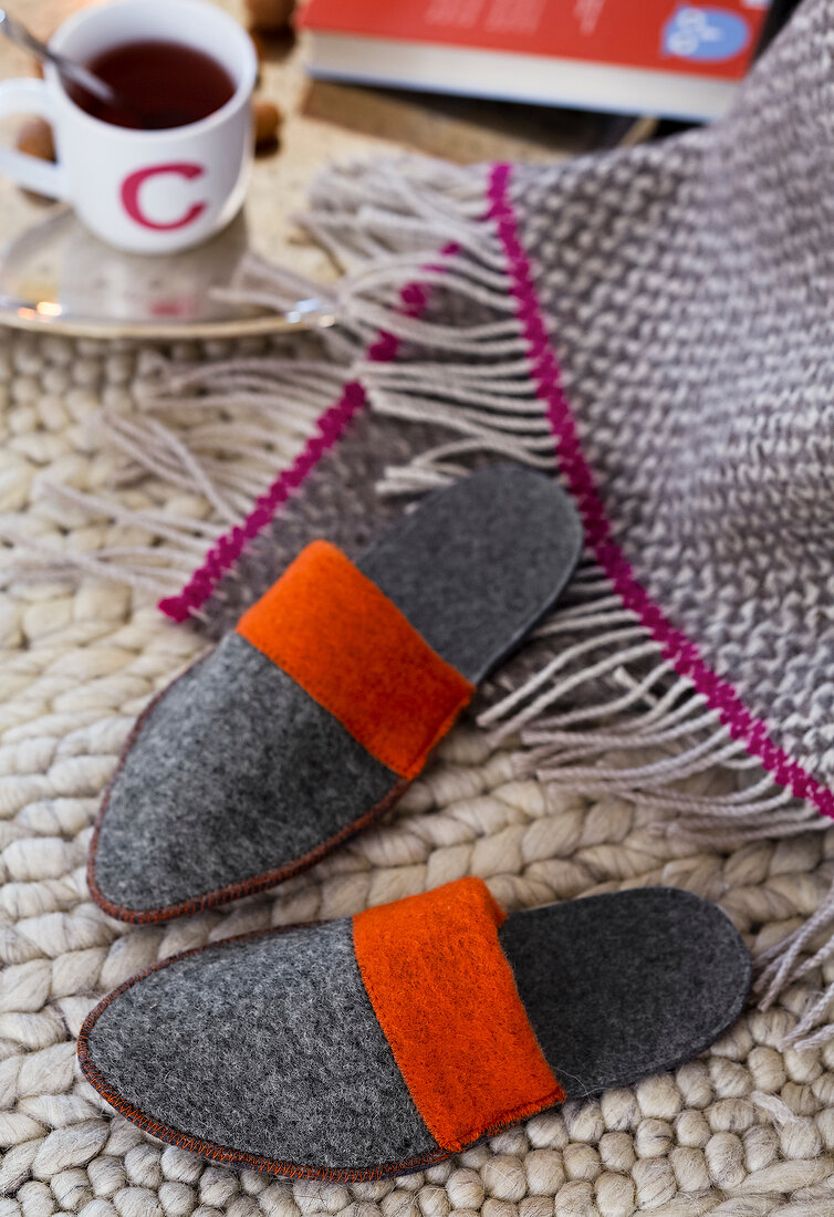 Grey felt slippers on rug