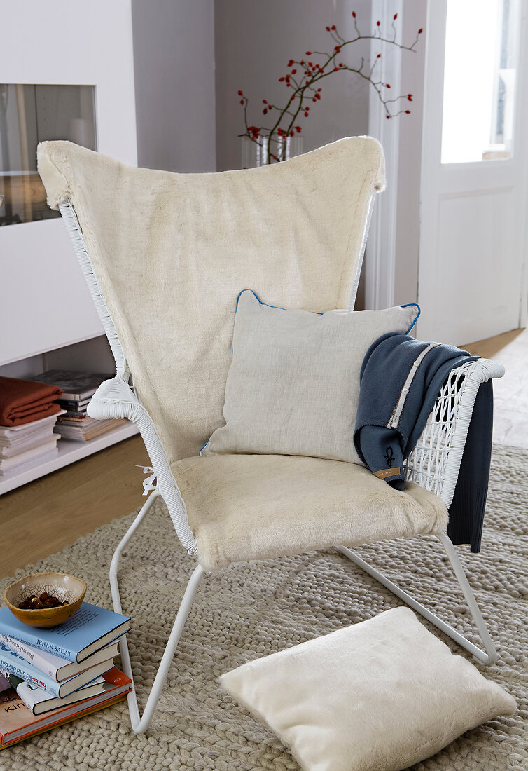 Living room with rattan chair and creme cushions