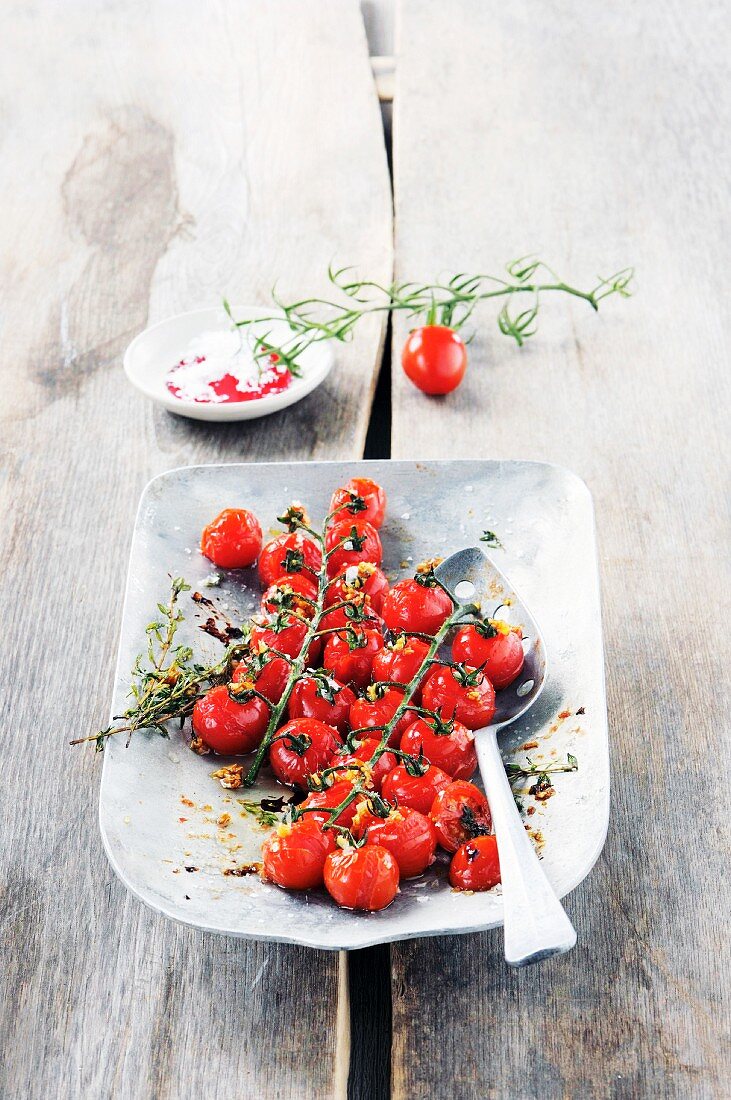 A bowl of vine tomatoes with rosemary