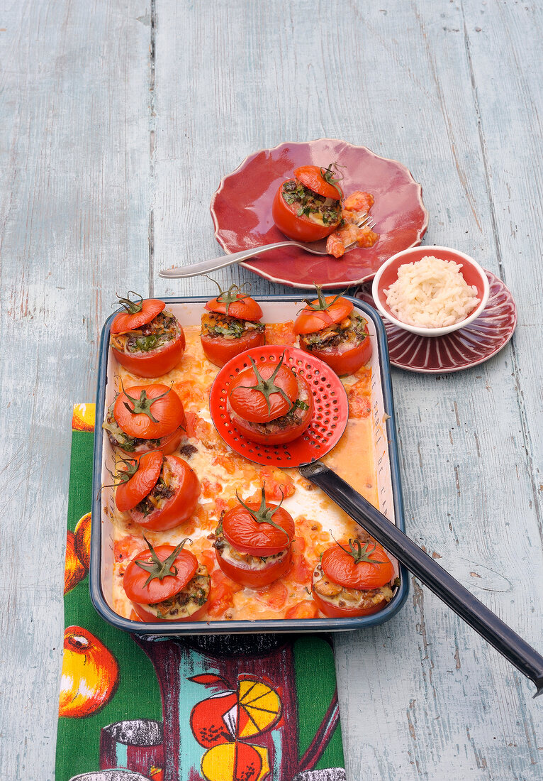 Stuffed tomatoes with strainer on tray
