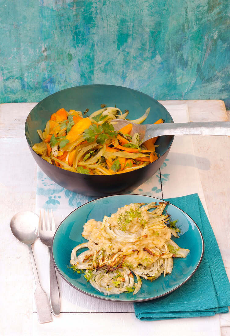 Carrots in bowl and baked fennel on plate