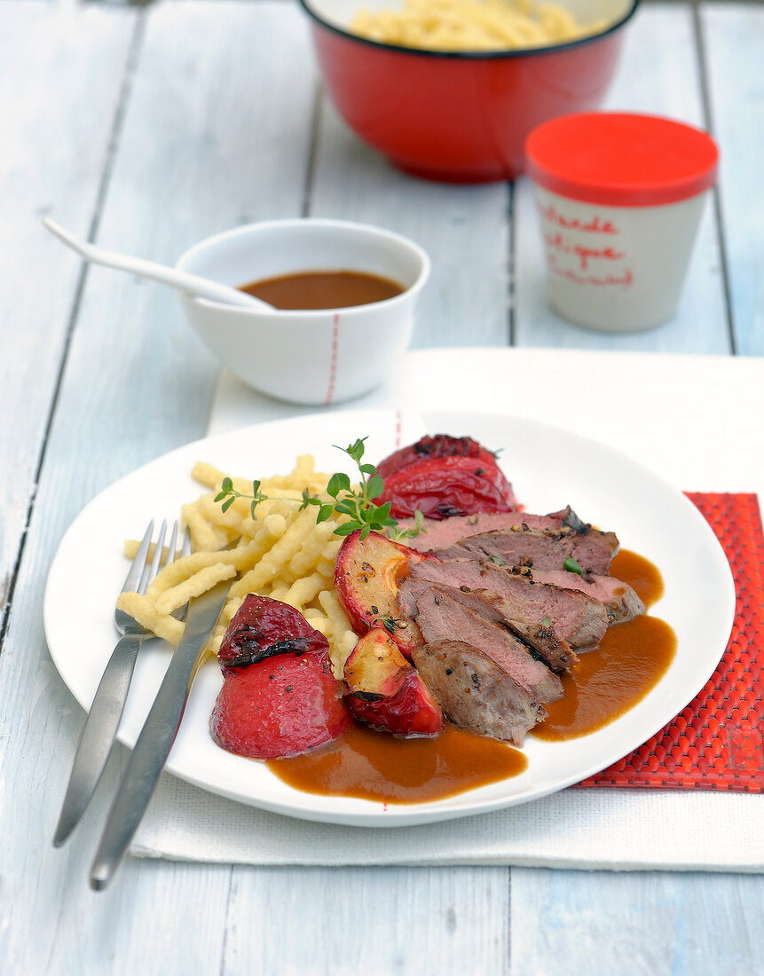 Fillet with sauce and tomato on plate