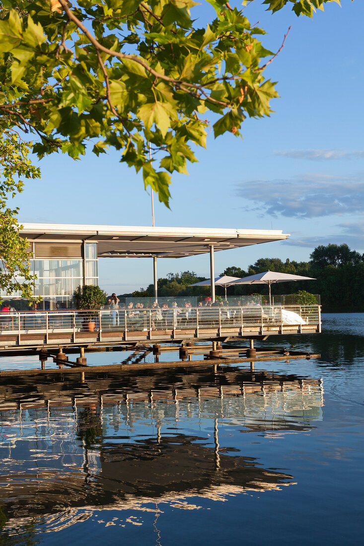 People sitting at terrace of Pier 51 Restaurant in Maschsee, Hannover, Germany