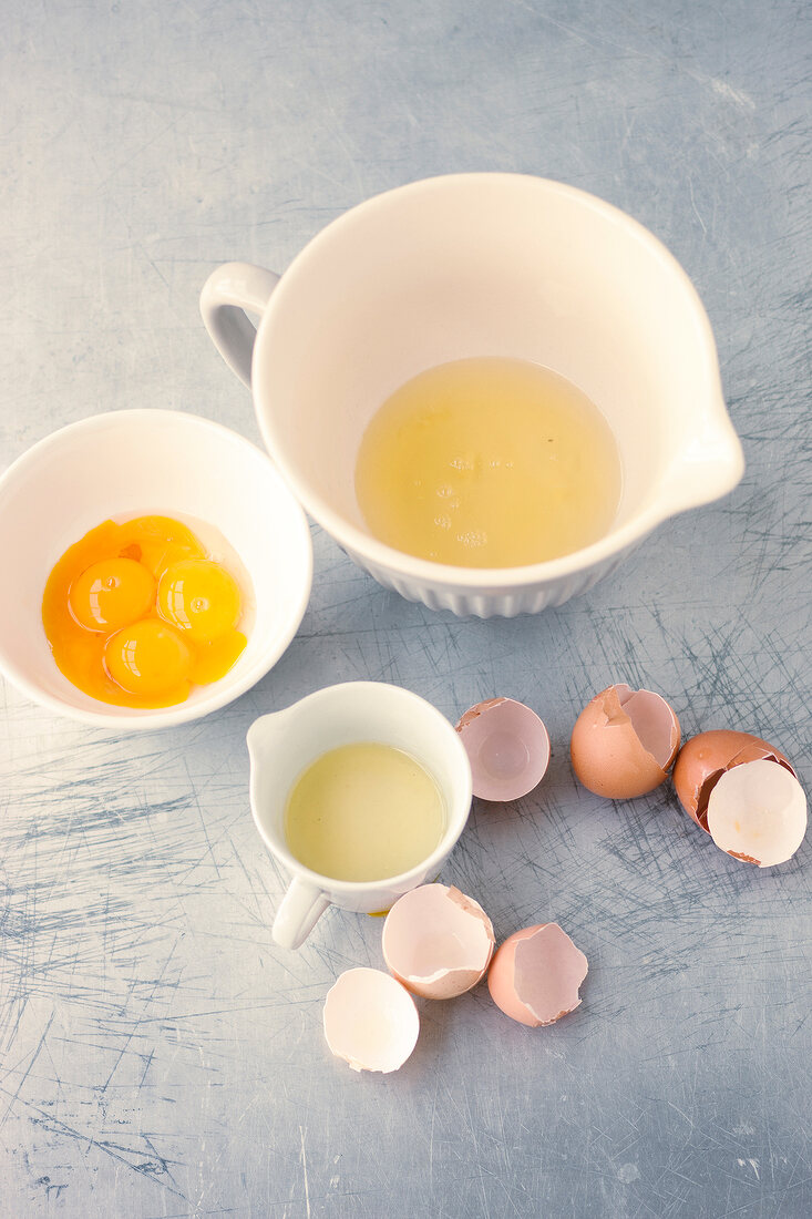 Egg yolks and other ingredients in bowls for preparing sponge cake, step 1