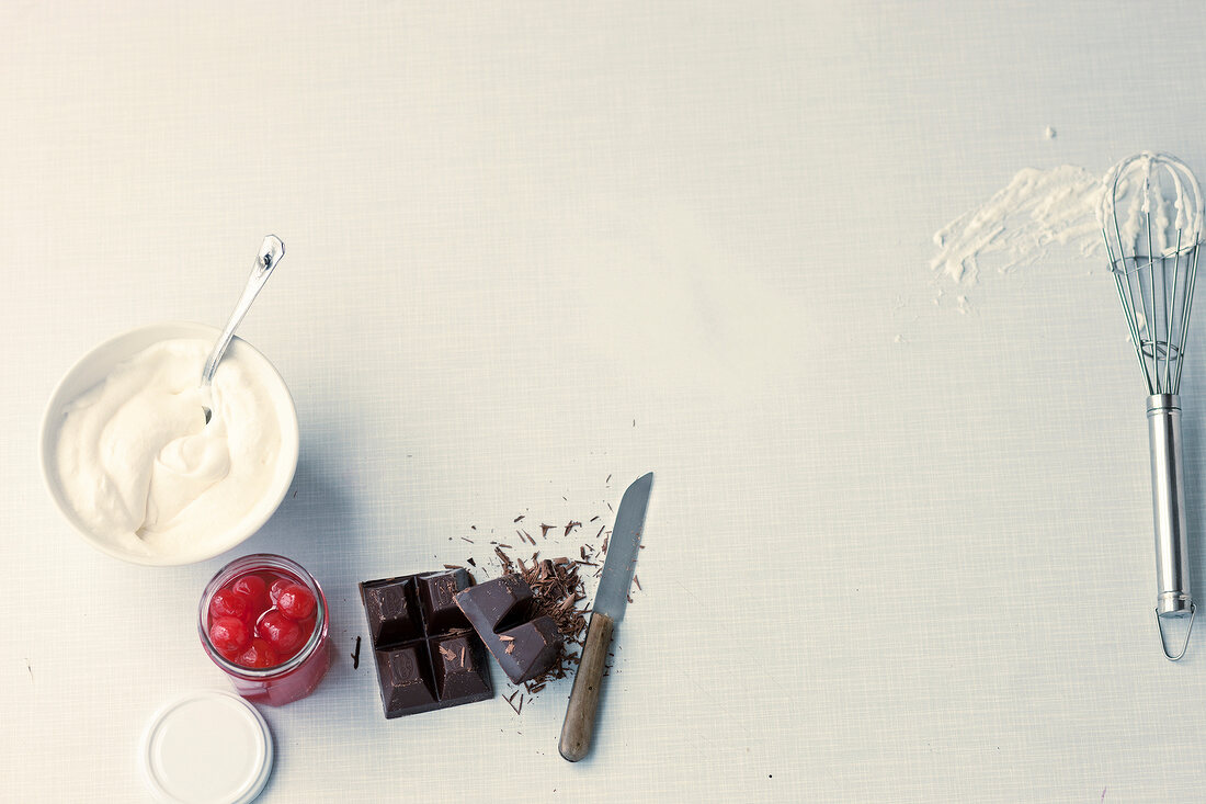 Various ingredients for black forest with cherry on white background