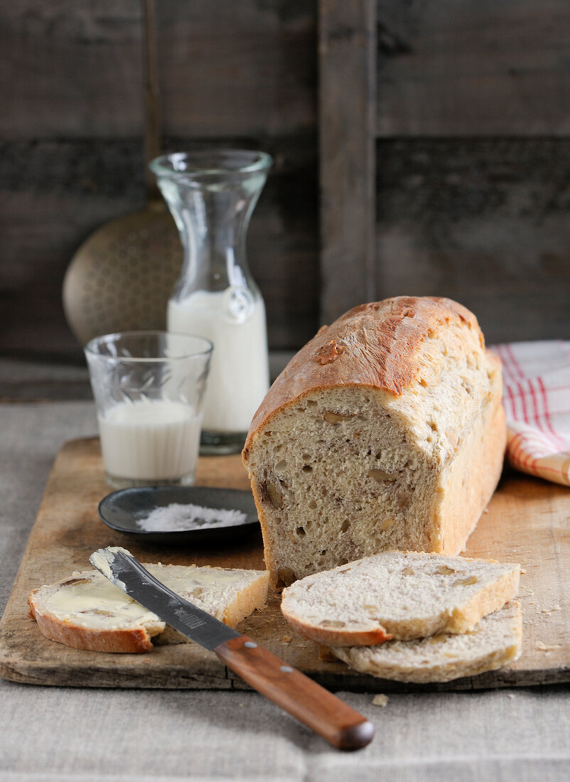 Slices of spelt bread with butter on chopping board