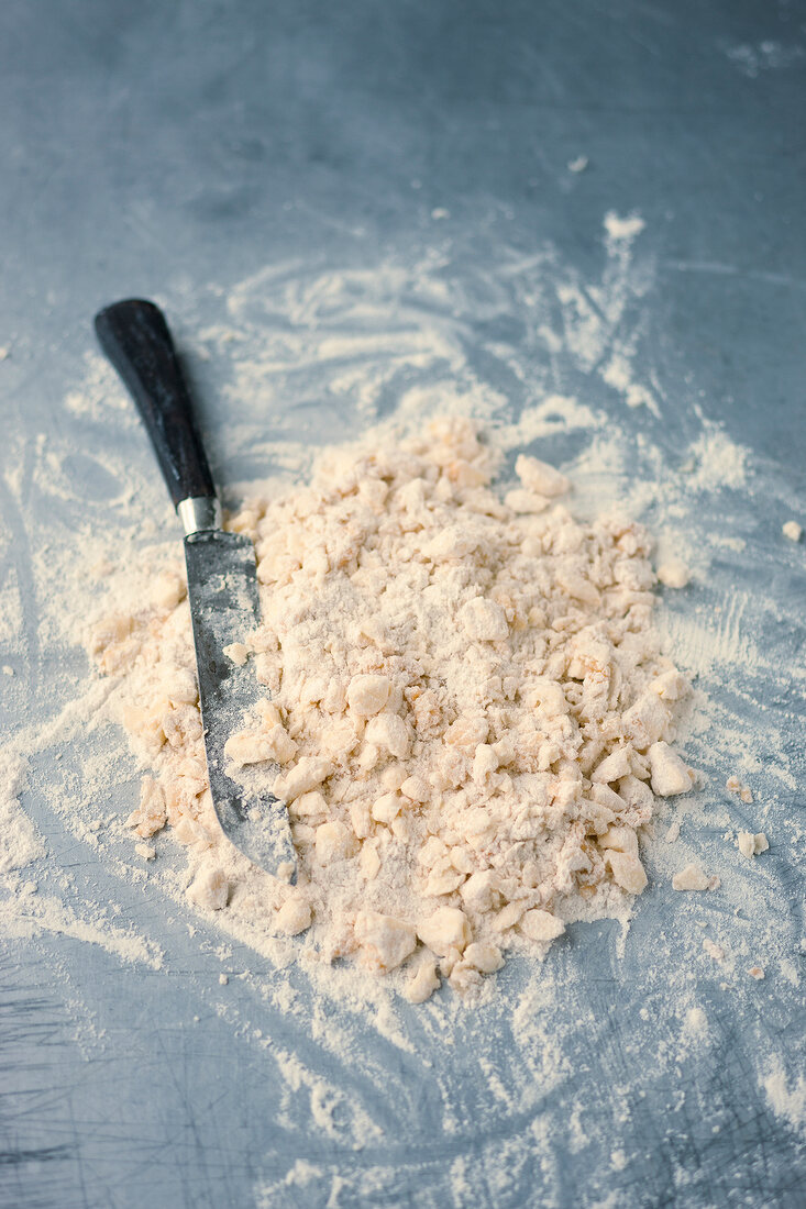 Flour, egg yolk and butter being mixed for preparation of short crust, step 2