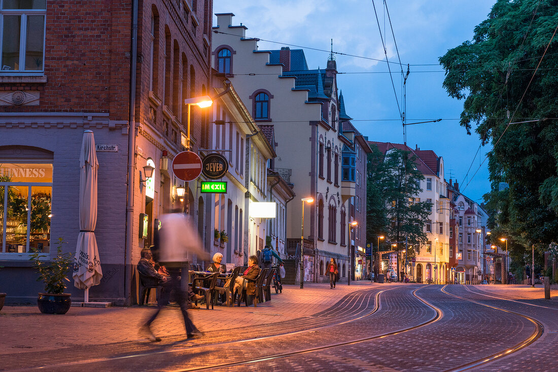 People at Davenstedter road at dusk in Linden, Hannover, Germany