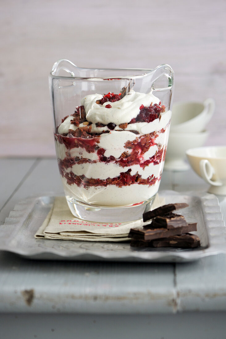 Cranberry with cream and chocolate in glass
