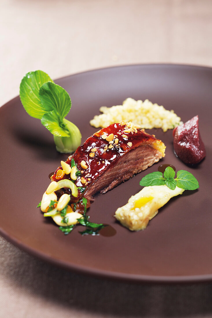 Close-up of oriental goose breast on plate