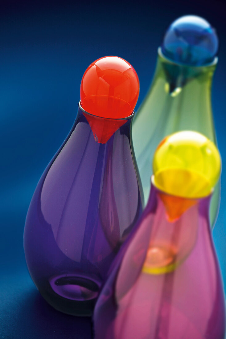 Close-up of colorful glass carafes