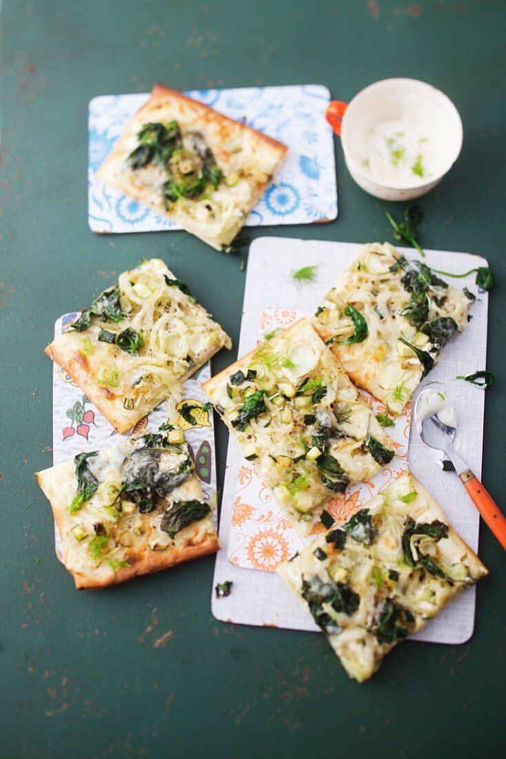 A pizza topped with fennel, spinach and Appenzeller cheese
