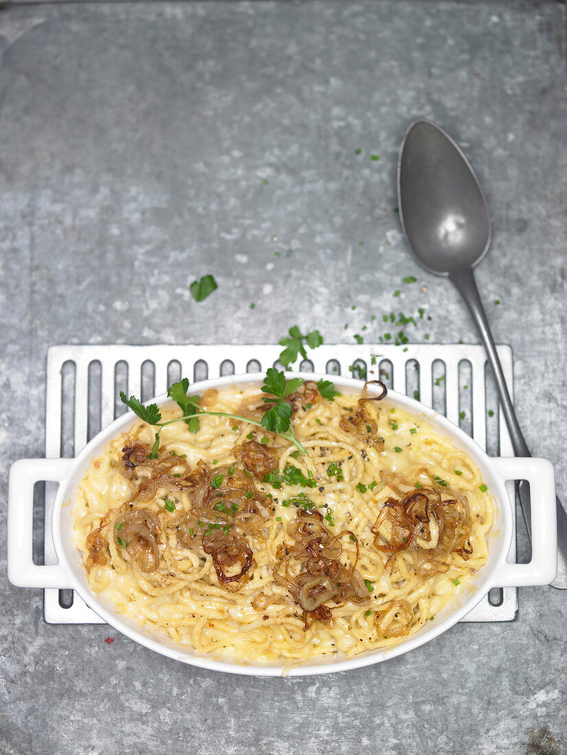 Cheese noodles on plate with spoon besides it