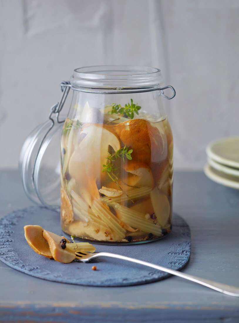 Porcini mushrooms and celery with wurzsud in glass jar