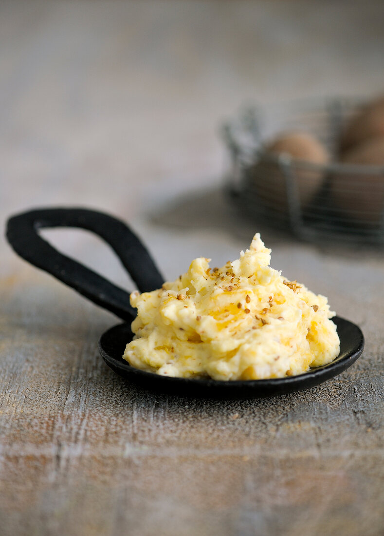 Potato and root mash on black serving dish