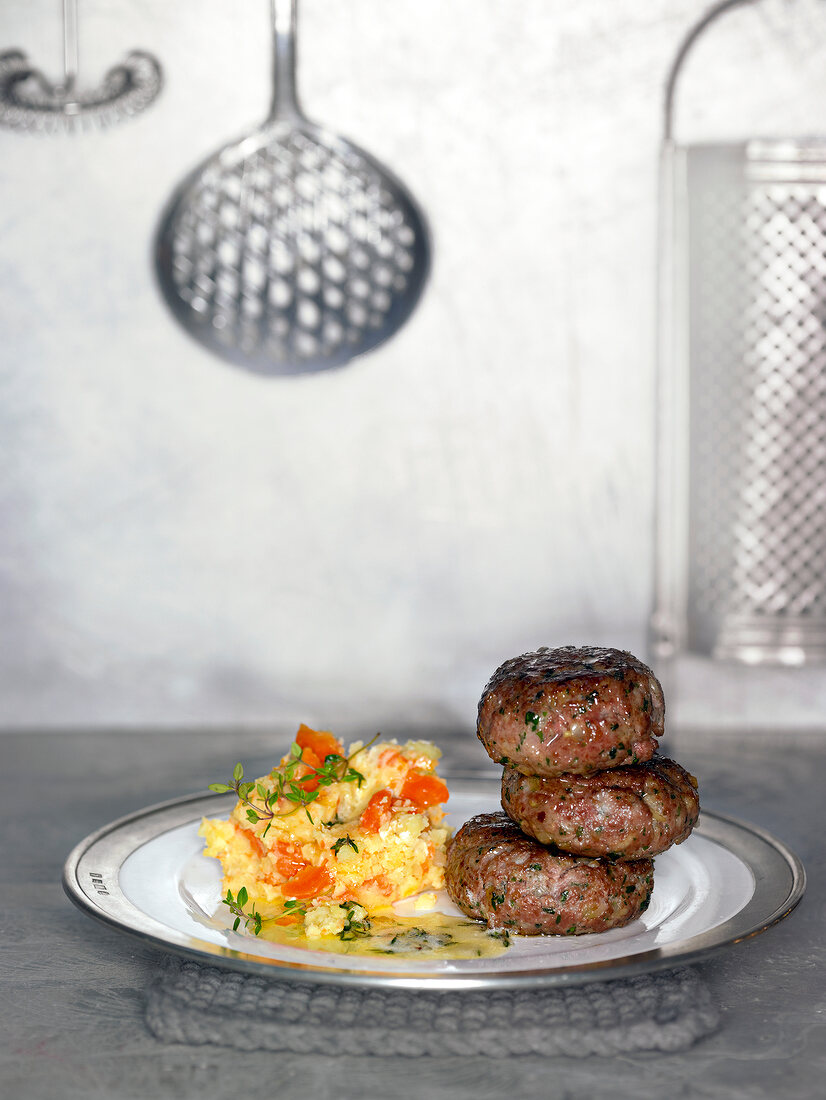 Meatballs with mashed potato and carrot on plate