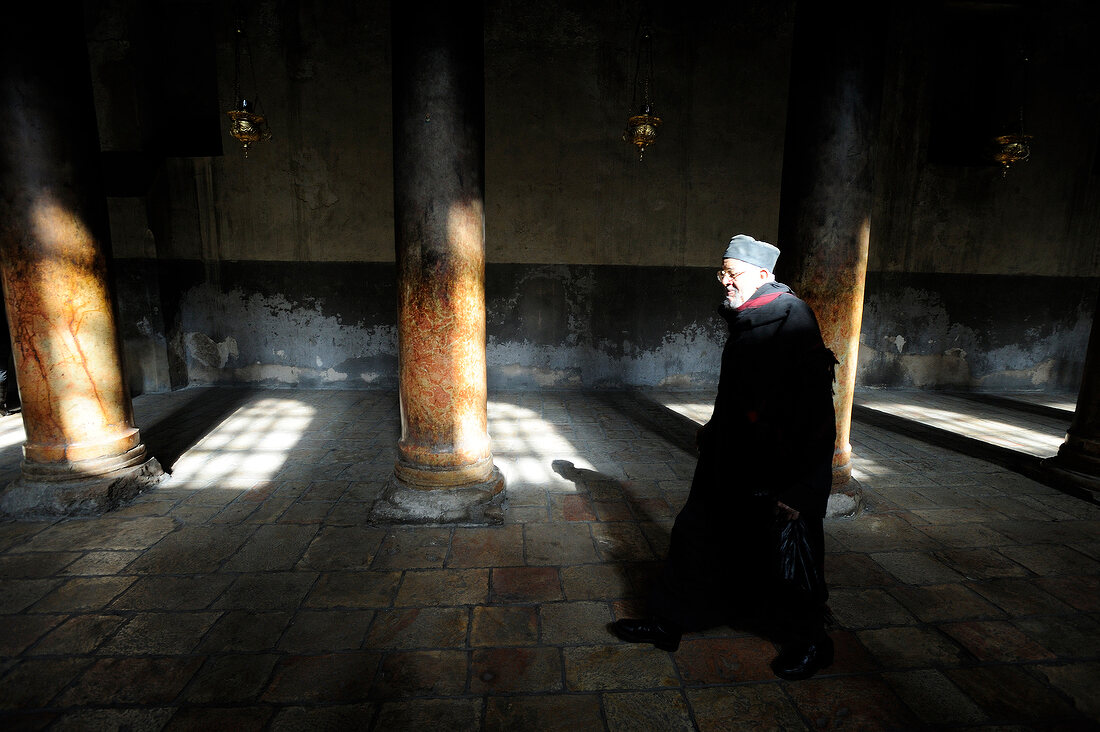 Jewish man standing in front of column in Church of Nativity, Bethlehem, West Bank, Israel
