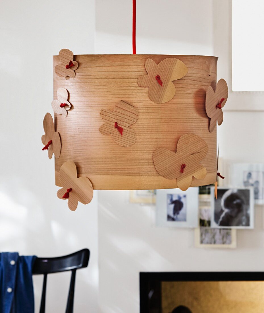 Pendant lampshade made from wood veneer decorated with wooden butterflies