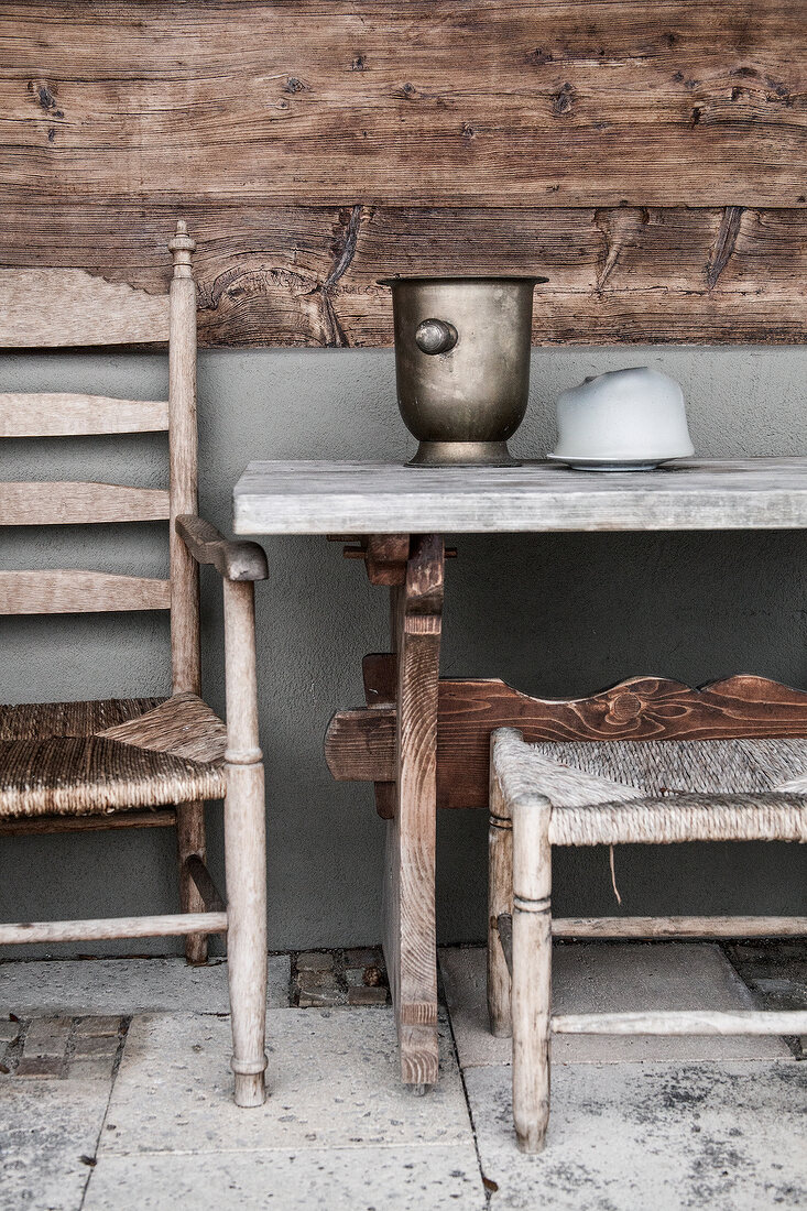 Wooden chair, wooden table, rustic decor, with wooden wall in background