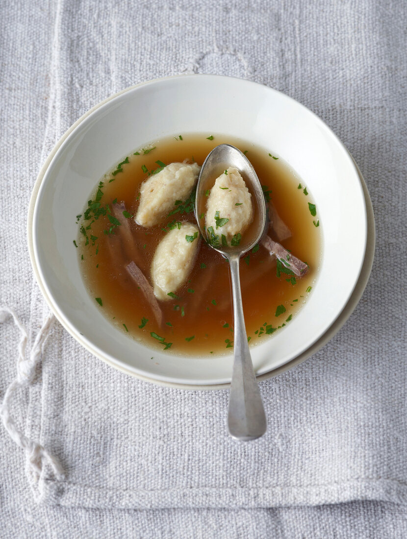 Beef broth with parsnip in bowl