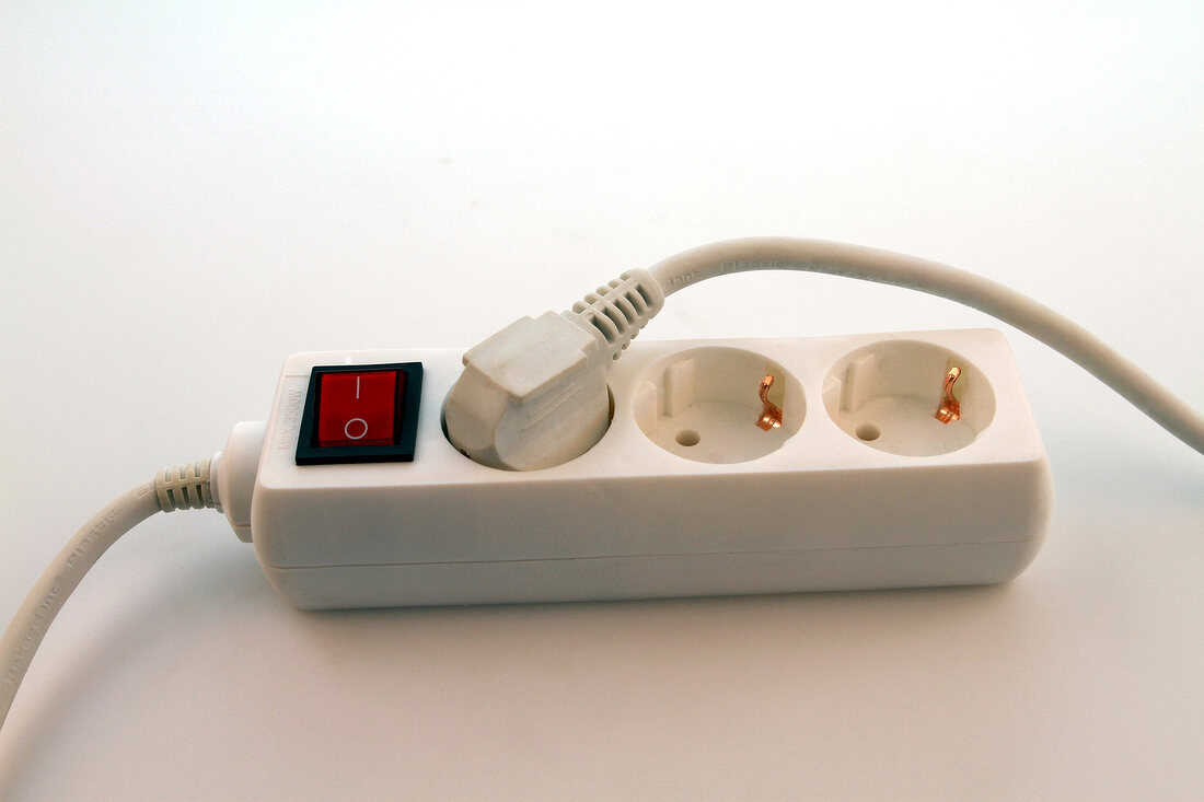 Close-up of triple plug extension on white background
