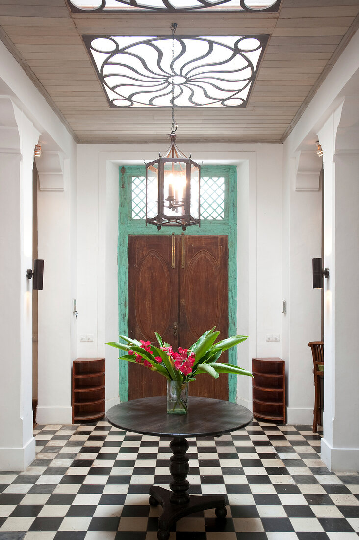 Interior with checker board tiles and table with vase, Galle Fort, Sri Lanka