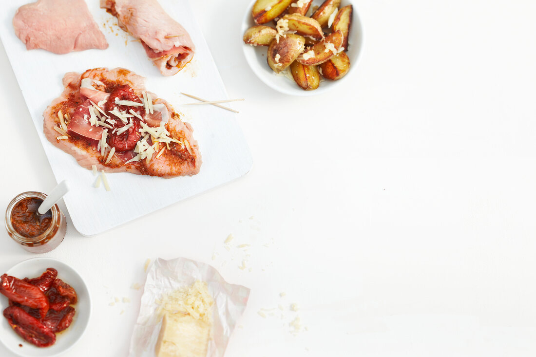 Ingredients for involtini with tomato filling on white background