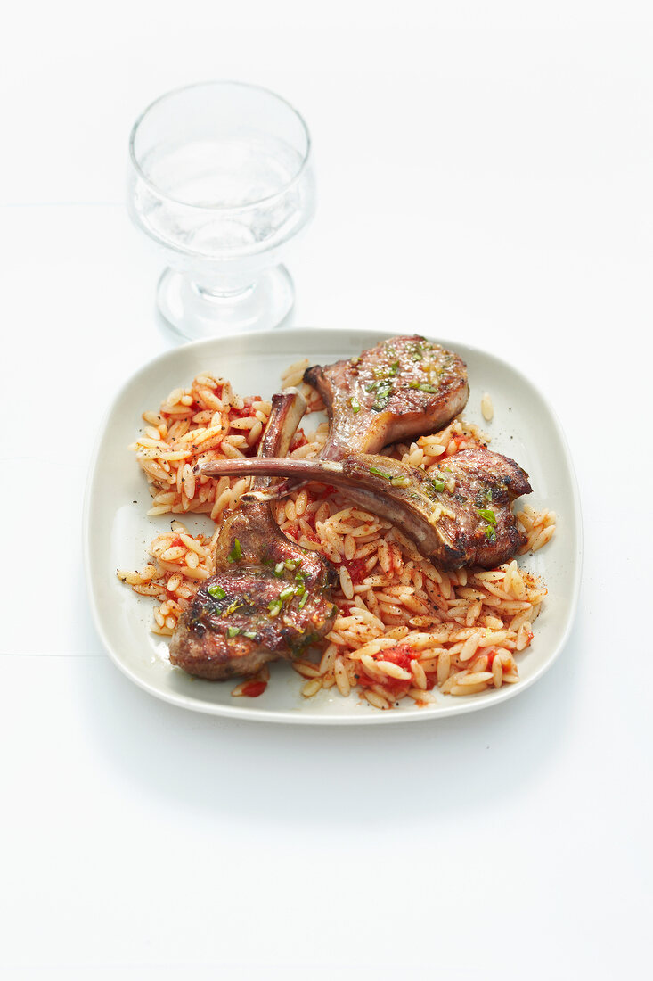 Lamb chops with cinnamon noodles on plate