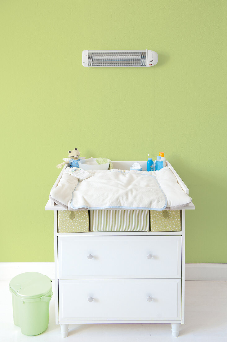 Baby changing table with heater above 
