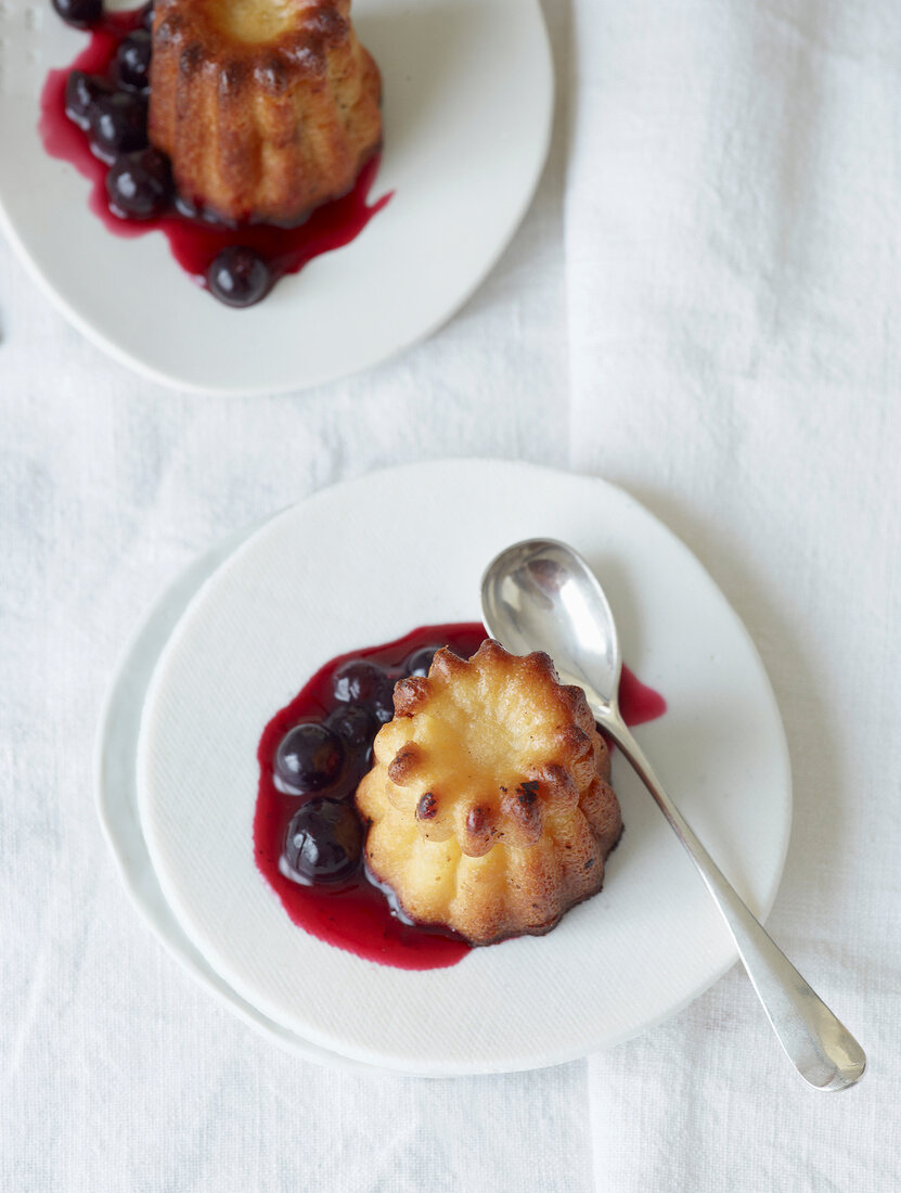 Canneles with berries on plate