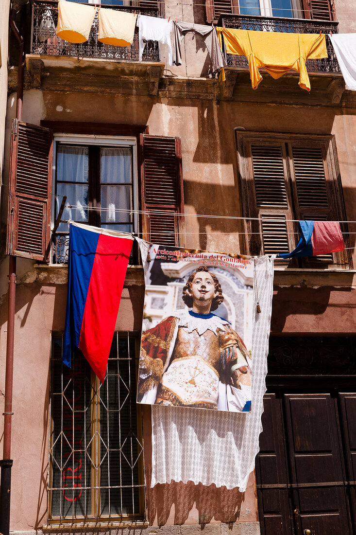 Flag on facade, Sardinia, Italy