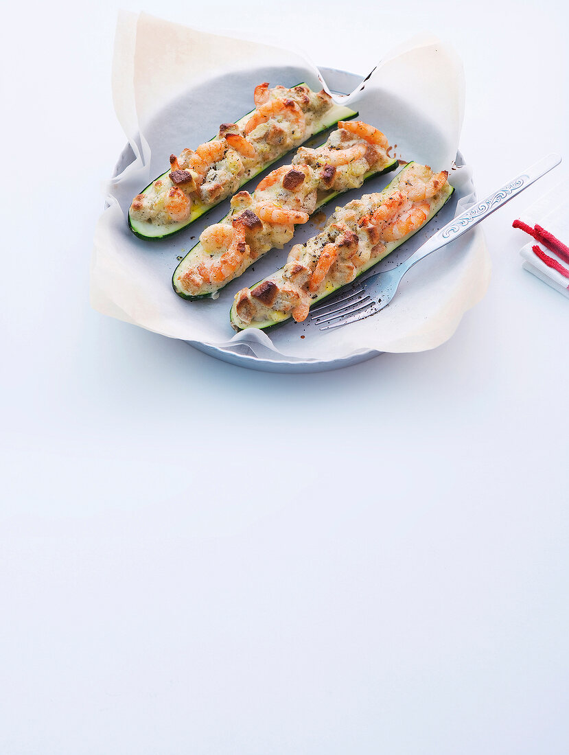 Shrimp on shuttle zucchini on plate